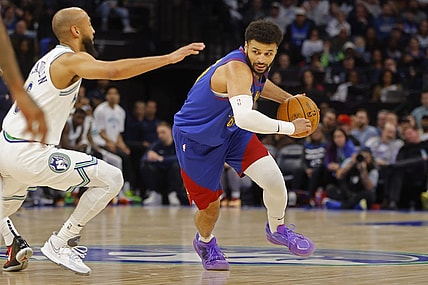 Mar 19, 2024; Minneapolis, Minnesota, USA; Denver Nuggets guard Jamal Murray (27) works around Minnesota Timberwolves guard Jordan McLaughlin (6) in the second quarter at Target Center. Mandatory Credit: Bruce Kluckhohn-USA TODAY Sports