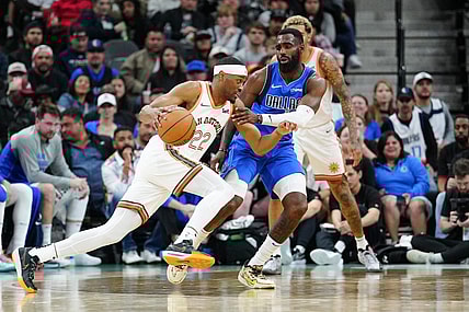 Mar 19, 2024; San Antonio, Texas, USA;  San Antonio Spurs guard Malaki Branham (22) dribbles against Dallas Mavericks forward Tim Hardaway Jr. (10) in the second half at Frost Bank Center. Mandatory Credit: Daniel Dunn-USA TODAY Sports