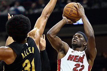 Mar 20, 2024; Cleveland, Ohio, USA; Miami Heat forward Jimmy Butler (22) shoots beside Cleveland Cavaliers center Jarrett Allen (31) in the second quarter at Rocket Mortgage FieldHouse. Mandatory Credit: David Richard-USA TODAY Sports