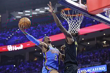 Mar 20, 2024; Oklahoma City, Oklahoma, USA; Oklahoma City Thunder guard Shai Gilgeous-Alexander (2) goes to the basket as Utah Jazz forward Taylor Hendricks (0) defends during the second quarter at Paycom Center. Mandatory Credit: Alonzo Adams-USA TODAY Sports