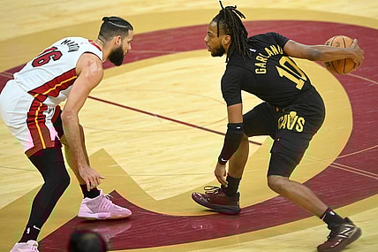 Mar 20, 2024; Cleveland, Ohio, USA; Cleveland Cavaliers guard Darius Garland (10) dribbles beside Miami Heat forward Caleb Martin (16) in the fourth quarter at Rocket Mortgage FieldHouse. Mandatory Credit: David Richard-USA TODAY Sports