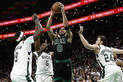 Mar 20, 2024; Boston, Massachusetts, USA; Boston Celtics forward Jayson Tatum (0) goes to the basket between Milwaukee Bucks guard Pat Connaughton (24) and forward Bobby Portis (9) during the second half at TD Garden. Mandatory Credit: Winslow Townson-USA TODAY Sports