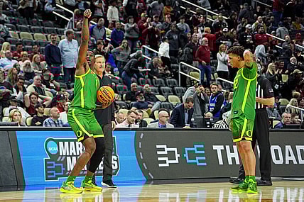 Mar 21, 2024; Pittsburgh, PA, USA; Oregon Ducks center N'Faly Dante (1) and guard Jadrian Tracey (22) celebrate with head coach Dana Altman after beating the South Carolina Gamecocks in the first round of the 2024 NCAA Tournament at PPG Paints Arena. Mandatory Credit: Gregory Fisher-USA TODAY Sports