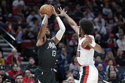 Mar 22, 2024; Portland, Oregon, USA; LA Clippers forward Paul George (13) shoots the ball over Portland Trail Blazers guard Scoot Henderson (00) during the second half at Moda Center. Mandatory Credit: Soobum Im-USA TODAY Sports