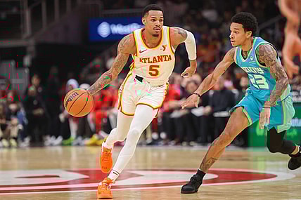 Mar 23, 2024; Atlanta, Georgia, USA; Atlanta Hawks guard Dejounte Murray (5) is defended by Charlotte Hornets guard Tre Mann (23) in the first quarter at State Farm Arena. Mandatory Credit: Brett Davis-USA TODAY Sports