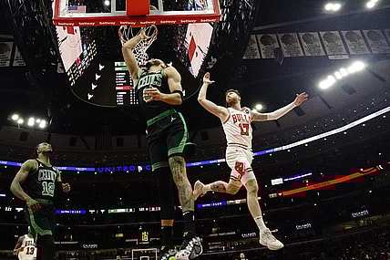 Mar 23, 2024; Chicago, Illinois, USA; Boston Celtics forward Jayson Tatum (0) scores on Chicago Bulls forward Onuralp Bitim (17) during the first quarter at United Center. Mandatory Credit: David Banks-USA TODAY Sports