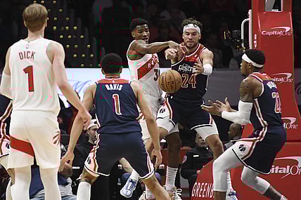 Mar 23, 2024; Washington, District of Columbia, USA;  Toronto Raptors guard Ochai Agbaji (30) and Washington Wizards forward Corey Kispert (24) leap for a loose ball during the first half at Capital One Arena. Mandatory Credit: Tommy Gilligan-USA TODAY Sports