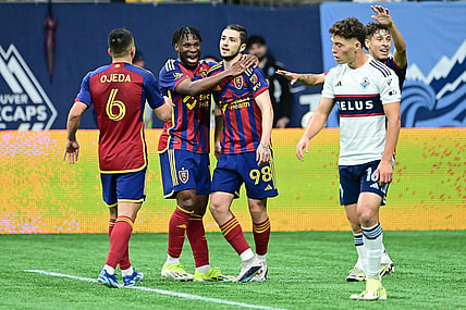 Mar 23, 2024; Vancouver, British Columbia, CAN; Real Salt Lake defender Alexandros Katranis (98) celebrates his second half goal against Vancouver Whitecaps FC with midfielders Emeka Eneli (14) and Braian Ojeda (6) at BC Place. Mandatory Credit: Simon Fearn-USA TODAY Sports