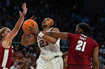 Texas forward Aaliyah Moore (23) is fouled by Alabama forward Essence Cody (21).