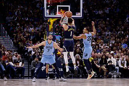 Mar 25, 2024; Denver, Colorado, USA; Denver Nuggets forward Michael Porter Jr. (1) attempts a three point shot against Memphis Grizzlies guard Desmond Bane (22) and forward Santi Aldama (7) in the first quarter at Ball Arena. Mandatory Credit: Isaiah J. Downing-USA TODAY Sports