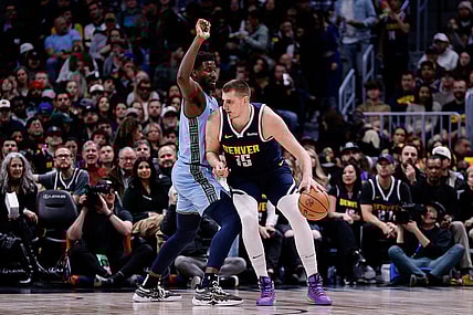 Mar 25, 2024; Denver, Colorado, USA; Denver Nuggets center Nikola Jokic (15) controls the ball against Memphis Grizzlies forward Jaren Jackson Jr. (13) in the second quarter at Ball Arena. Mandatory Credit: Isaiah J. Downing-USA TODAY Sports