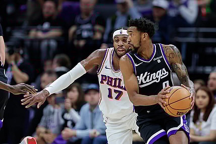 Mar 25, 2024; Sacramento, California, USA; Sacramento Kings guard Malik Monk (0) controls the ball against Philadelphia 76ers guard Buddy Hield (17) during the second quarter at Golden 1 Center. Mandatory Credit: Sergio Estrada-USA TODAY Sports