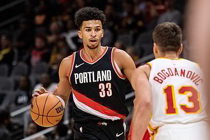Mar 27, 2024; Atlanta, Georgia, USA; Portland Trail Blazers forward Toumani Camara (33) dribbles the ball against Atlanta Hawks guard Bogdan Bogdanovic (13) during the first quarter at State Farm Arena. Mandatory Credit: Jordan Godfree-USA TODAY Sports