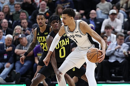Mar 27, 2024; Salt Lake City, Utah, USA; San Antonio Spurs center Victor Wembanyama (1) moves the ball away from Utah Jazz forward Taylor Hendricks (0) during the second quarter at Delta Center. Mandatory Credit: Rob Gray-USA TODAY Sports