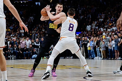 Mar 27, 2024; Denver, Colorado, USA; Denver Nuggets center Nikola Jokic (15) controls the ball as Denver Nuggets forward Peyton Watson (8) guards in the first quarter at Ball Arena. Mandatory Credit: Isaiah J. Downing-USA TODAY Sports