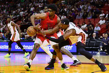 Mar 29, 2024; Miami, Florida, USA; Portland Trail Blazers guard Scoot Henderson (00) and Miami Heat center Bam Adebayo (13) battle for possession during the first quarter at Kaseya Center. Mandatory Credit: Sam Navarro-USA TODAY Sports