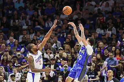 Mar 29, 2024; Orlando, Florida, USA; Orlando Magic guard Cole Anthony (50) shoots the ball over LA Clippers forward Kawhi Leonard (2) during the second half at KIA Center. Mandatory Credit: Mike Watters-USA TODAY Sports
