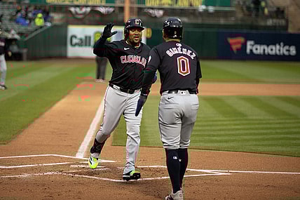 Mar 29, 2024; Oakland, California, USA; Cleveland Guardians third baseman José Ramírez (11) is greeted by teammate Andrés Giménez (0) after hitting a two-run home run against the Oakland Athletics during the first inning at Oakland-Alameda County Coliseum. Mandatory Credit: D. Ross Cameron-USA TODAY Sports