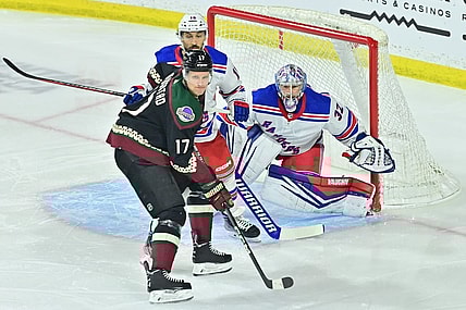 Mar 30, 2024; Tempe, Arizona, USA;  New York Rangers goaltender Jonathan Quick (32) defends as Arizona Coyotes center Nick Bjugstad (17) and center Vincent Trocheck (16) battle for position in the first period at Mullett Arena. Mandatory Credit: Matt Kartozian-USA TODAY Sports