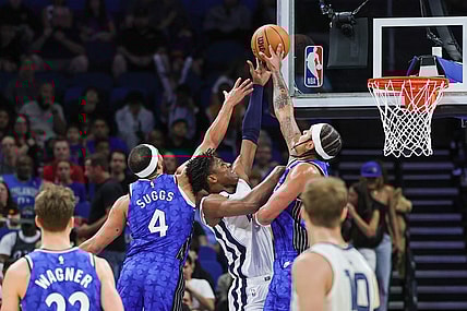 Mar 30, 2024; Orlando, Florida, USA; Orlando Magic forward Paolo Banchero (5) and guard Jalen Suggs (4) block a shot attempt by Memphis Grizzlies forward GG Jackson (45) during the first quarter at KIA Center. Mandatory Credit: Mike Watters-USA TODAY Sports
