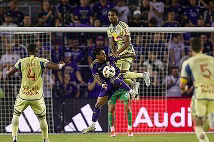 Mar 30, 2024; Orlando, Florida, USA; Orlando City midfielder Facundo Torres (10) and New York Red Bulls defender Kyle Duncan (6) battle for the ball during the first half at Inter&Co Stadium. Mandatory Credit: Russell Lansford-USA TODAY Sports