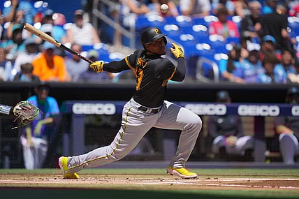 Mar 31, 2024; Miami, Florida, USA;  Pittsburgh Pirates third baseman Ke'Bryan Hayes (13) hits a short ground ball in the first inning against the Miami Marlins at loanDepot Park. Mandatory Credit: Jim Rassol-USA TODAY Sports