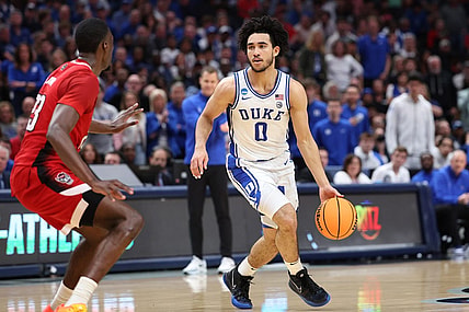 Mar 31, 2024; Dallas, TX, USA; Duke Blue Devils guard Jared McCain (0) controls the ball against North Carolina State Wolfpack forward Mohamed Diarra (23) in the first half in the finals of the South Regional of the 2024 NCAA Tournament at American Airline Center. Mandatory Credit: Kevin Jairaj-USA TODAY Sports