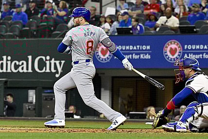 Mar 31, 2024; Arlington, Texas, USA; Chicago Cubs designated hitter Ian Happ (8) hits a double and drives in two runs during the fourth inning against the Texas Rangers at Globe Life Field. Mandatory Credit: Jerome Miron-USA TODAY Sports