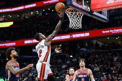 Mar 31, 2024; Washington, District of Columbia, USA; Miami Heat guard Terry Rozier (2) shoots a layup over Washington Wizards forward Marvin Bagley III (35) during the first quarter at Capital One Arena. Mandatory Credit: Reggie Hildred-USA TODAY Sports