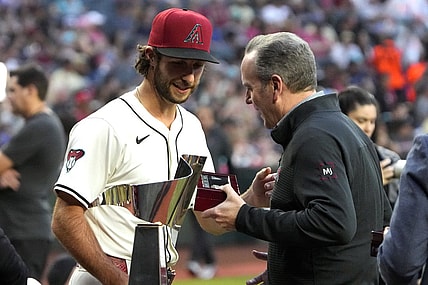 Mar 29, 2024; Phoenix, Arizona, USA; Arizona Diamondbacks President/CEO Derrick Hall presents pitcher Zac Gallen (23) a National League Championship Ring before a game against the Colorado Rockies at Chase Field. Mandatory Credit: Rick Scuteri-USA TODAY Sports