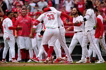 Cincinnati Reds center fielder Will Benson (30) embraces Cincinnati Reds first baseman Christian Encarnacion-Strand (33) after he hit a walk-off home run in the ninth inning of a baseball game against the Washington Nationals, Sunday, March 31, 2024, at Great American Ball Park in Cincinnati.