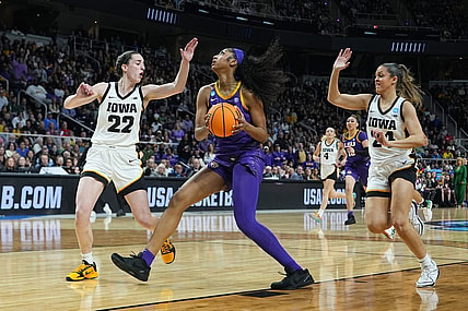 Apr 1, 2024; Albany, NY, USA; LSU Lady Tigers forward Angel Reese (10) controls the ball against Iowa Hawkeyes guard Caitlin Clark (22) and guard Gabbie Marshall (24) in the first half in the finals of the Albany Regional in the 2024 NCAA Tournament at MVP Arena. Mandatory Credit: Gregory Fisher-USA TODAY Sports