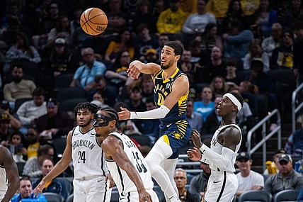 Apr 1, 2024; Indianapolis, Indiana, USA; Indiana Pacers guard Tyrese Haliburton (0) passes the ball while Brooklyn Nets center Nic Claxton (33) defends in the second half at Gainbridge Fieldhouse. Mandatory Credit: Trevor Ruszkowski-USA TODAY Sports