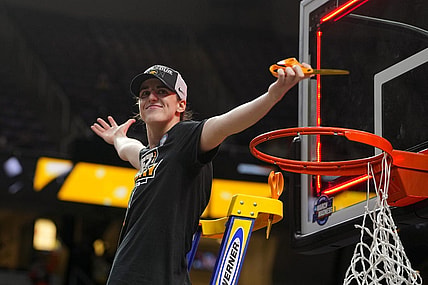 Apr 1, 2024; Albany, NY, USA; Iowa Hawkeyes guard Caitlin Clark (22) cuts the net after defeating the LSU Lady Tigers in the finals of the Albany Regional in the 2024 NCAA Tournament at MVP Arena. Mandatory Credit: Gregory Fisher-USA TODAY Sports