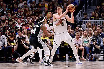 Apr 2, 2024; Denver, Colorado, USA; Denver Nuggets center Nikola Jokic (15) controls the ball as San Antonio Spurs center Victor Wembanyama (1) and guard Devonte' Graham (4) defend in the second quarter at Ball Arena. Mandatory Credit: Isaiah J. Downing-USA TODAY Sports