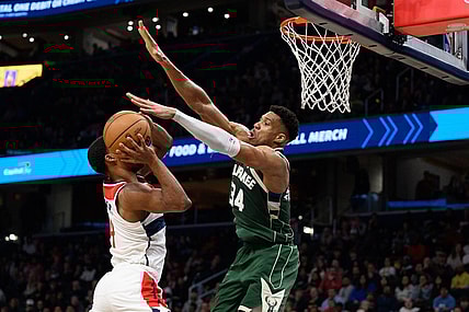 Apr 2, 2024; Washington, District of Columbia, USA; Milwaukee Bucks forward Giannis Antetokounmpo (34) defends against Washington Wizards guard Jared Butler (4) during the fourth quarter at Capital One Arena. Mandatory Credit: Reggie Hildred-USA TODAY Sports