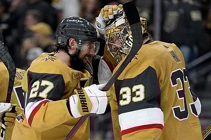 Vegas Golden Knights defenseman Shea Theodore (27) celebrates with goaltender Adin Hill (33) after Game 1 of the NHL hockey Stanley Cup Final against the Florida Panthers, Saturday, June 3, 2023