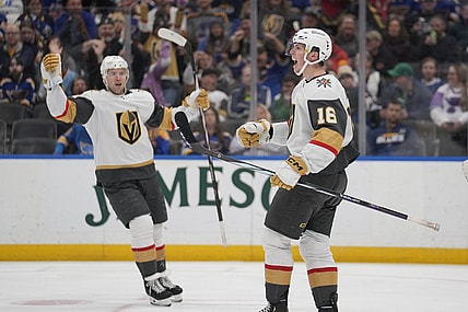 Vegas Golden Knights' Pavel Dorofeyev (16) celebrates after scoring as teammate Ben Hutton watches during the first period of an NHL hockey game against the St. Louis Blues Monday, March 25, 2024, in St. Louis. (AP Photo/Jeff Roberson)