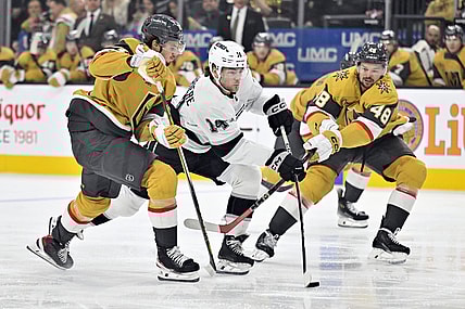 Los Angeles Kings right wing Alex Laferriere (14) skates between Vegas Golden Knights center Brett Howden (21) and center Tomas Hertl (48) during the first period of an NHL hockey game Tuesday, Oct. 22, 2024, in Las Vegas. (AP Photo/David Becker)