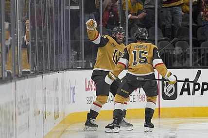 Vegas Golden Knights left wing Brandon Saad, left, celebrates after scoring against the Vancouver Canucks during the third period of an NHL hockey game Saturday, Feb. 22, 2025, in Las Vegas. (AP Photo/John Locher)