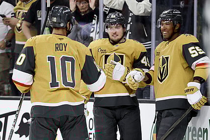 Vegas Golden Knights centers Nicolas Roy (10) and Ivan Barbashev (49) celebrate with right wing Keegan Kolesar (55) after Kolesar's goal during the second period of an NHL hockey game against the Chicago Blackhawks Thursday, Feb. 27, 2025, in Las Vegas. (AP Photo/Ian Maule)