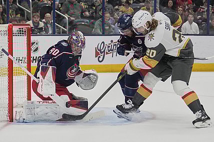 Vegas Golden Knights left wing Brandon Saad (20) shoots on Columbus Blue Jackets goaltender Elvis Merzlikins (90) next to defenseman Ivan Provorov (9) in the first period of an NHL hockey game Thursday, March 13, 2025, in Columbus, Ohio. (AP Photo/Sue Ogrocki)
