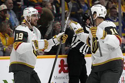Vegas Golden Knights right wing Reilly Smith (19) celebrates with Nicolas Roy (10) after Smith scored a goal against the Nashville Predators during the third period of an NHL hockey game Saturday, March 29, 2025, in Nashville, Tenn. (AP Photo/Mark Humphrey)