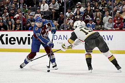 Colorado Avalanche center Nathan MacKinnon (29) skates against Vegas Golden Knights defenseman Noah Hanifin (15) in the first period of an NHL hockey game Tuesday, April 8, 2025, in Denver. (AP Photo/Geneva Heffernan)