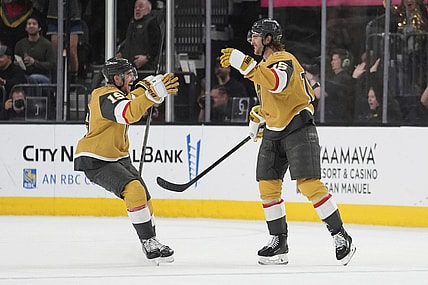 Vegas Golden Knights right wing Reilly Smith (19) celebrates after Vegas Golden Knights defenseman Noah Hanifin, right, scored against the Nashville Predators during the third period of an NHL hockey game Saturday, April 12, 2025, in Las Vegas. (AP Photo/John Locher)