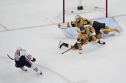 Edmonton Oilers center Leon Draisaitl (29) scores against Vegas Golden Knights goaltender Adin Hill (33) during overtime of Game 2 of a second-round NHL hockey playoff series Thursday, May 8, 2025, in Las Vegas. (AP Photo/John Locher)