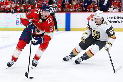 SUNRISE, FL - OCTOBER 25: Florida Panthers center Carter Verhaeghe (23) skates with the puck as Vegas Golden Knights right wing Mitch Marner (93) looks on in the second period during the game between the Golden Knights and the Florida Panthers on Saturday, October 25, 2025 at Amerant Bank Arena in Sunrise, FL.(Photo by Chris Arjoon/Icon Sportswire)