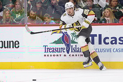 ST. PAUL, MN - DECEMBER 15: Vegas Golden Knights right wing Alexander Holtz (26) passes the puck during the NHL game between the Vegas Golden Knights and Minnesota Wild on December 15th, 2024, at the Xcel Energy Center in St. Paul, MN. (Photo by Bailey Hillesheim/Icon Sportswire)