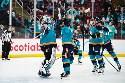 New York Sirens goalie Kayle Osborne celebrates a 4-3 win over the Montreal Victoire with teammates.