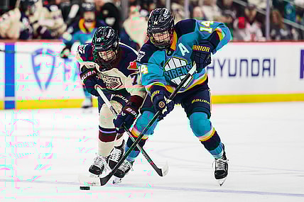 New York Sirens defender Jaime Bourbonnais and Montreal Victoire forward Jade Downie-Landry battle for the puck.